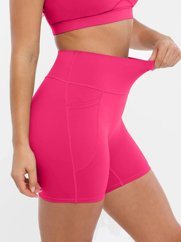 A model wearing a BRXL® Sports Bra Sculpted Shorts Sculpted Leggings Set in