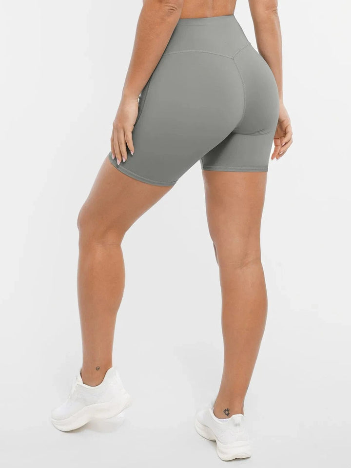 A model wearing a BRXL® Sports Bra Sculpted Shorts Sculpted Leggings Set in