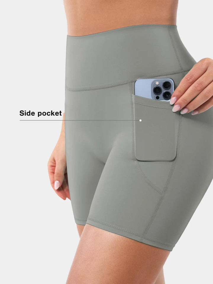 A model wearing a BRXL® Sports Bra Sculpted Shorts Sculpted Leggings Set in