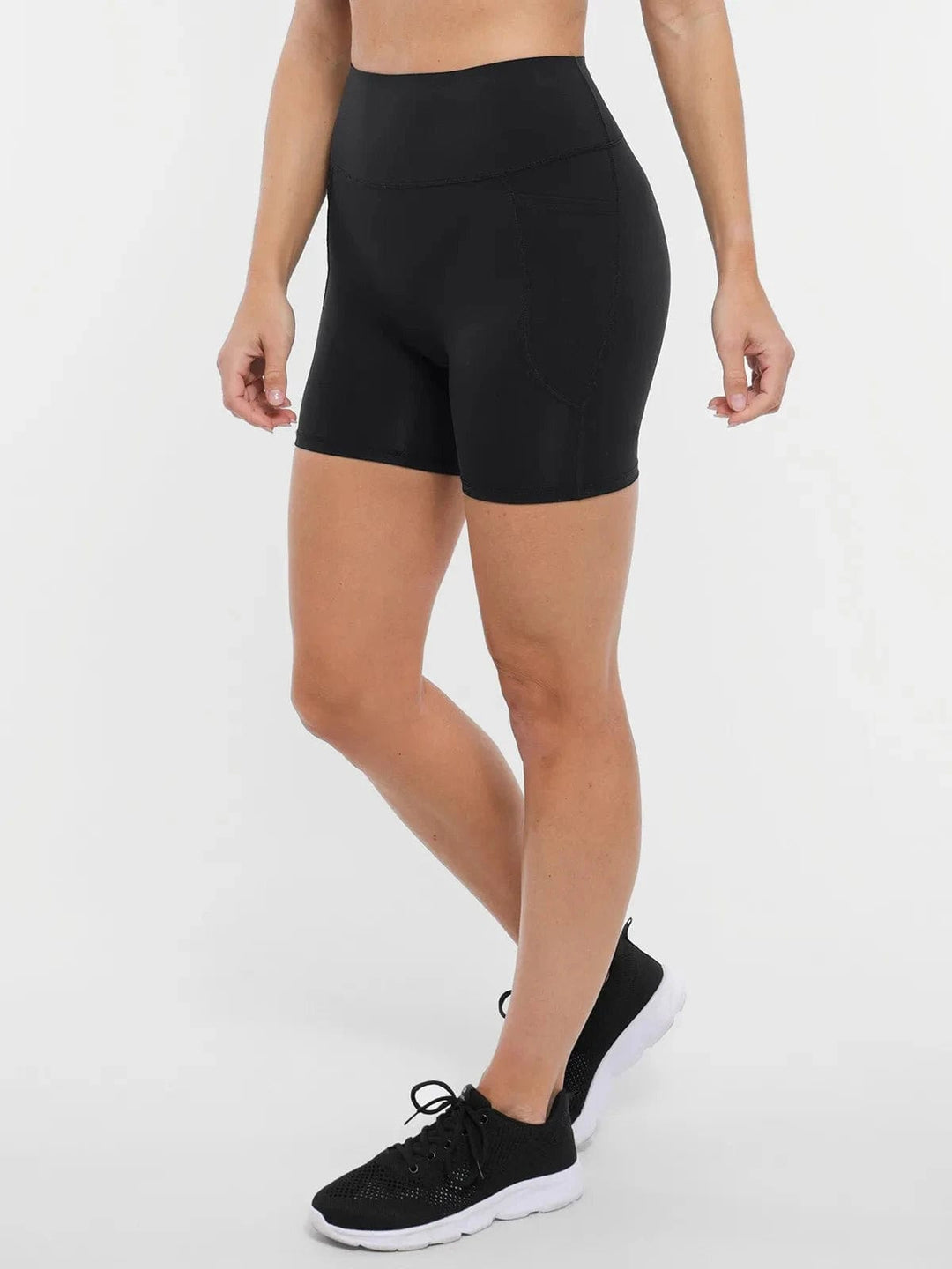 A model wearing a BRXL® Sports Bra Sculpted Shorts Sculpted Leggings Set in