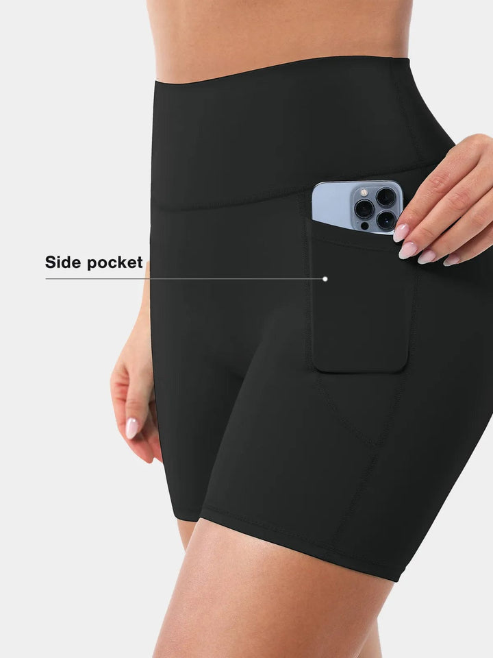 A model wearing a BRXL® Sports Bra Sculpted Shorts Sculpted Leggings Set in