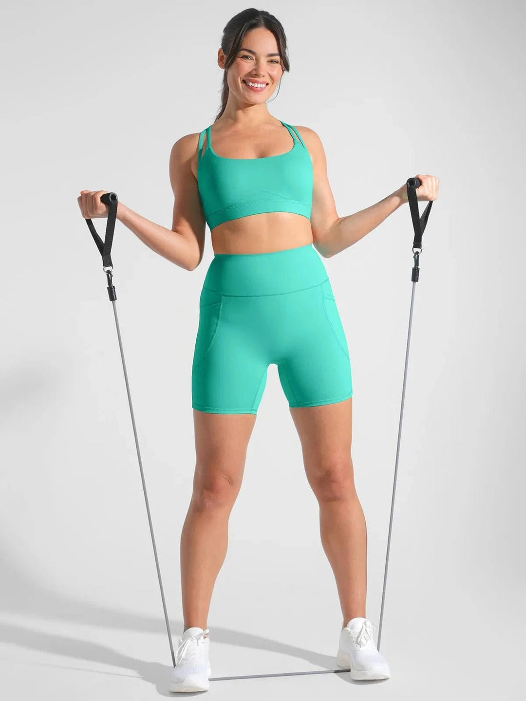 A model wearing a BRXL® Sports Bra Sculpted Shorts Sculpted Leggings Set in