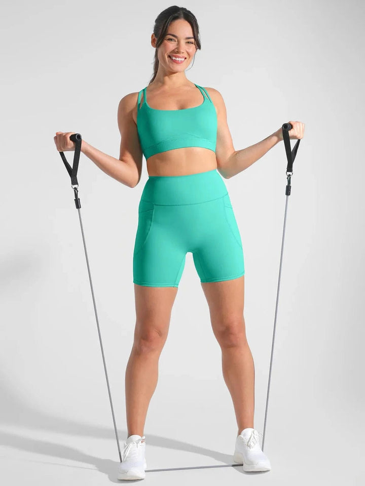 A model wearing a BRXL® Sports Bra Sculpted Shorts Sculpted Leggings Set in