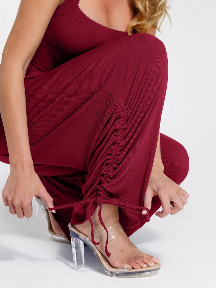 Burgundy ribbed shapewear jumpsuit with adjustable ruched leg detail