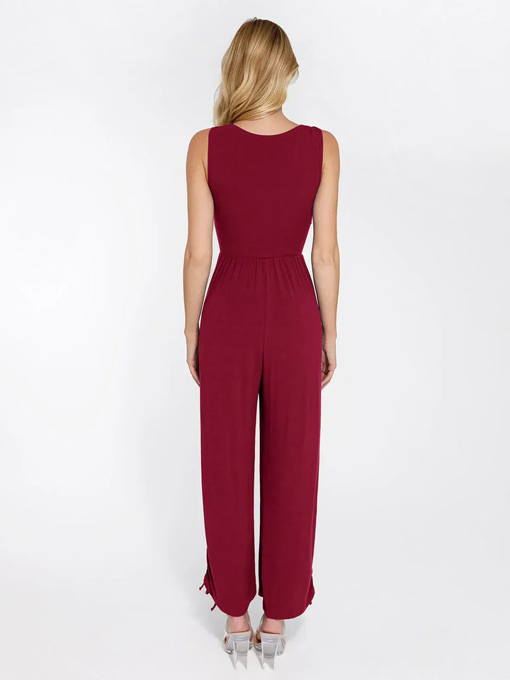 Burgundy wide leg shapewear jumpsuit with tummy control waist and adjustable legs, back view.