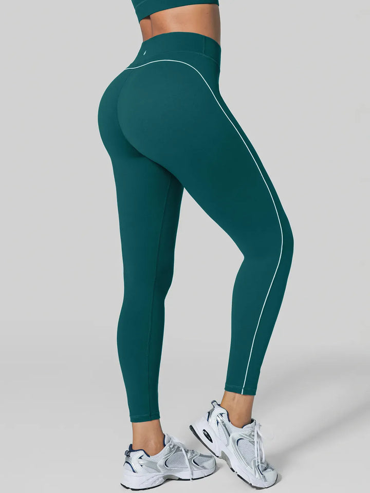 A model wearing a BRXL® Tummy Control High Rise Yoga Leggings in