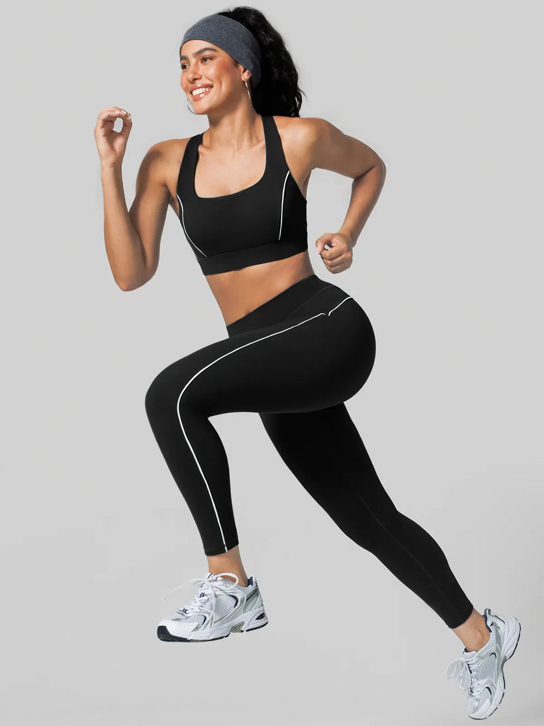 A model wearing a BRXL® Tummy Control High Rise Yoga Leggings in