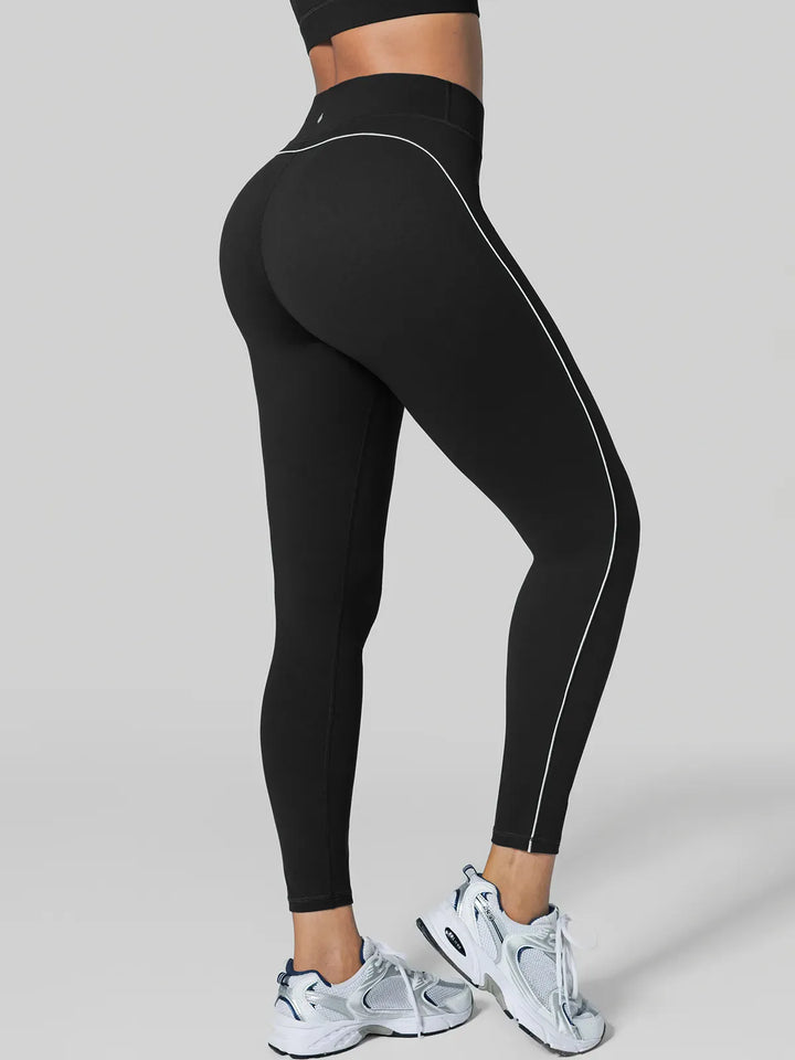 A model wearing a BRXL® Tummy Control High Rise Yoga Leggings in