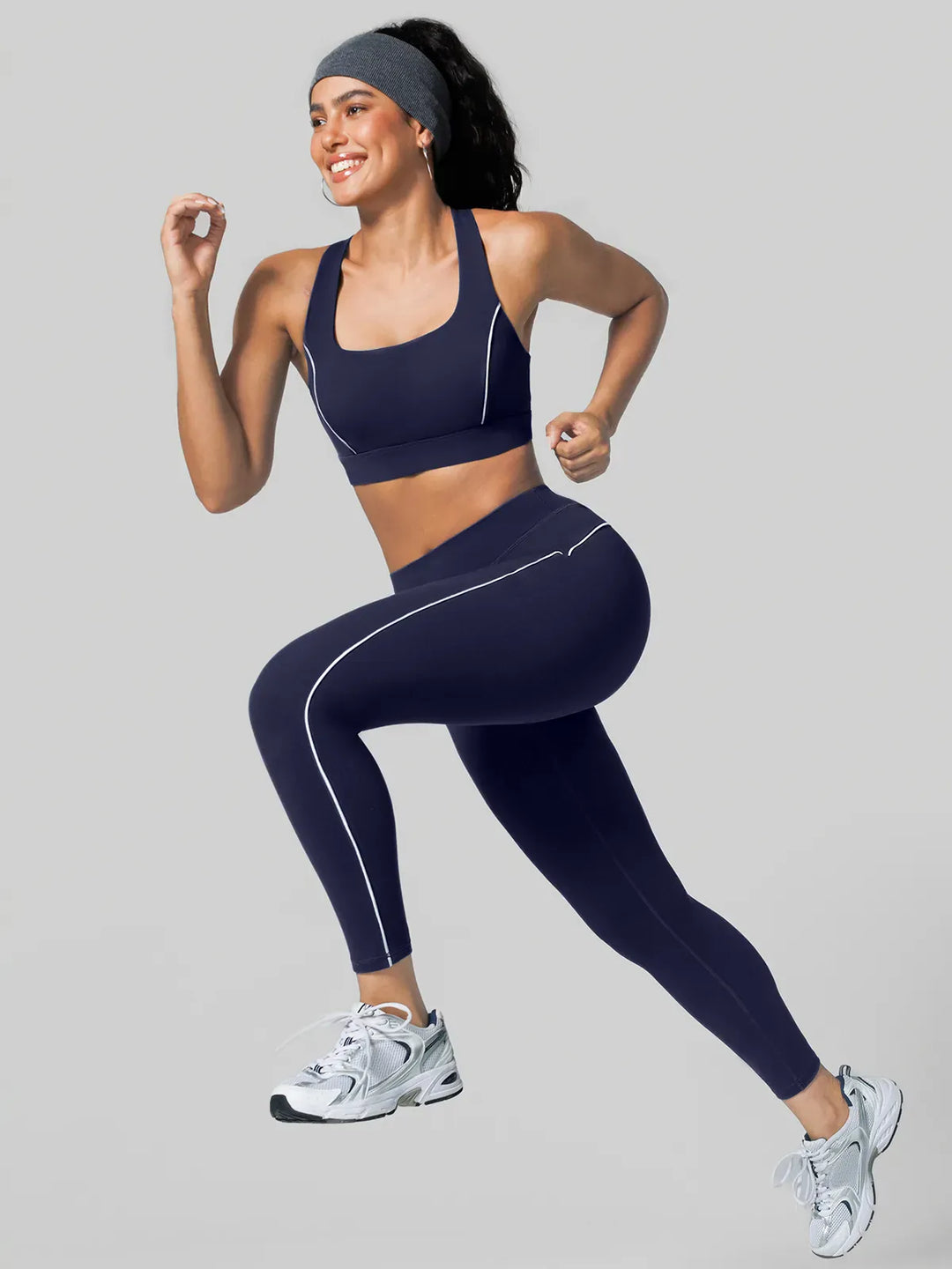 A model wearing a BRXL® Tummy Control High Rise Yoga Leggings