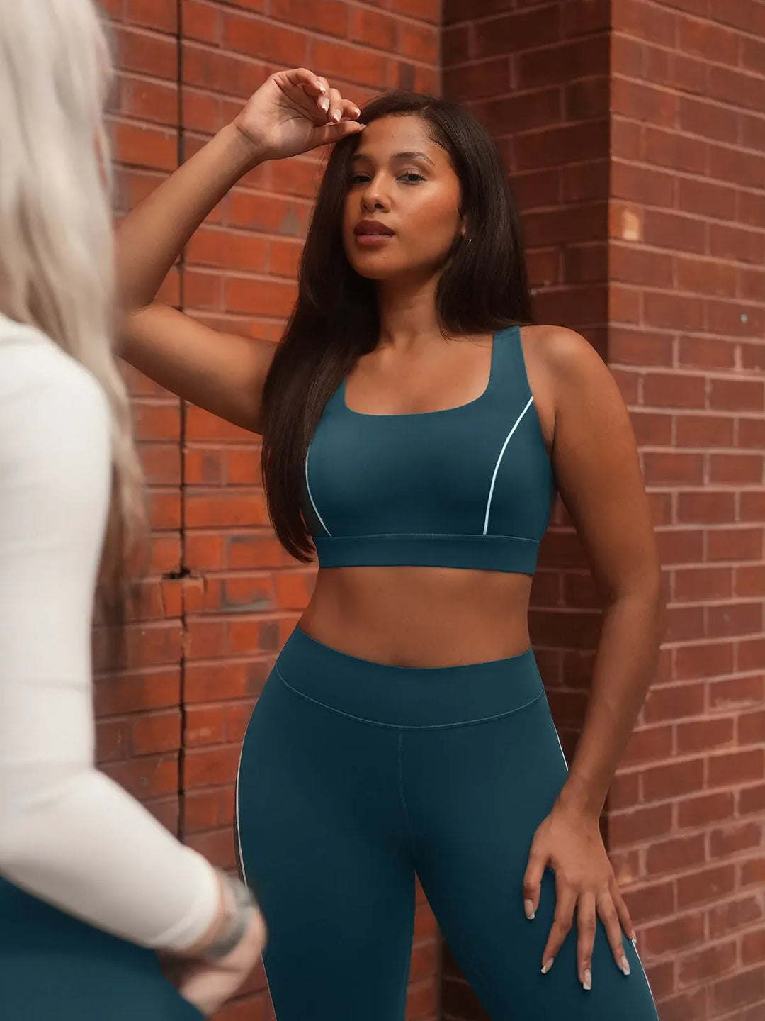 A model wearing a BRXL® Tummy Control High Rise Yoga Leggings in