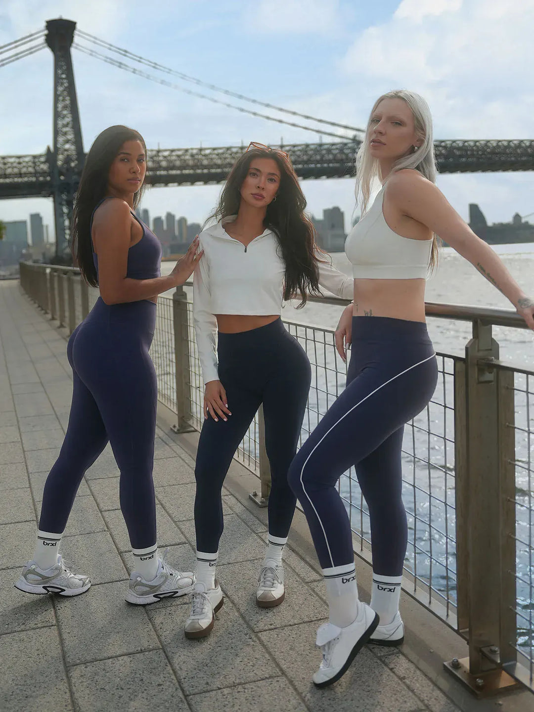 A model wearing a BRXL® Tummy Control High Rise Yoga Leggings in