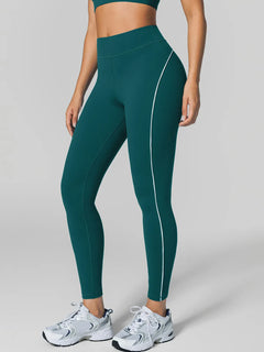 A model wearing a BRXL® Tummy Control High Rise Yoga Leggings in Green / XS