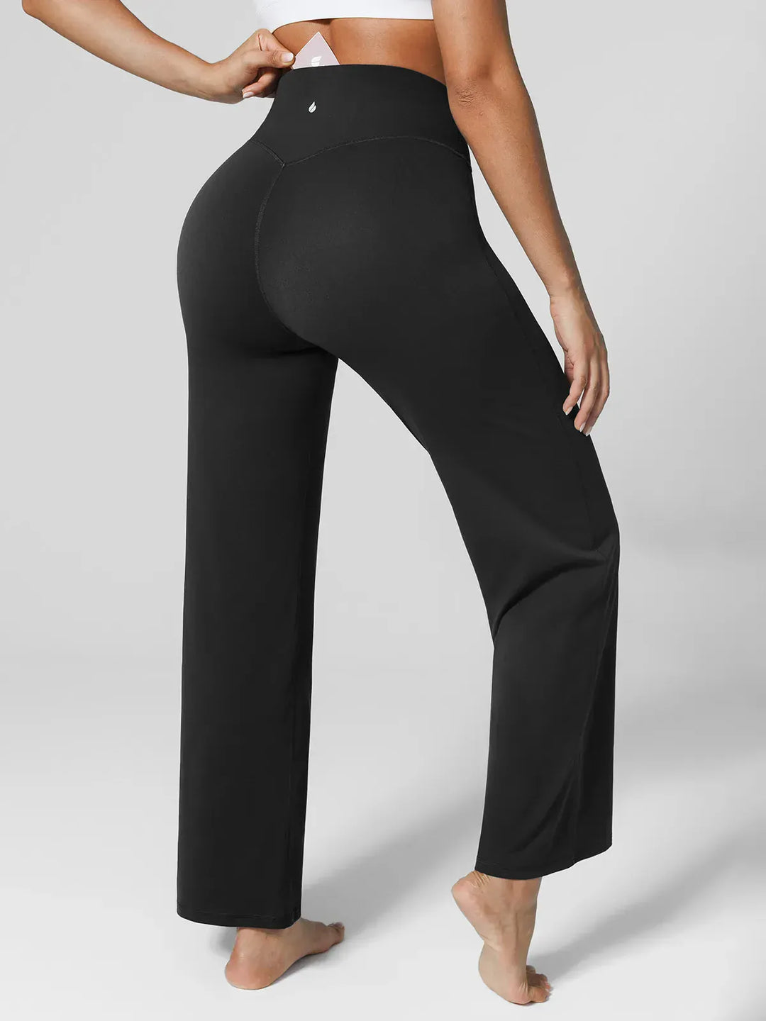 A model wearing a BRXL® Tummy Control Wide Leg Activewear Leggings in