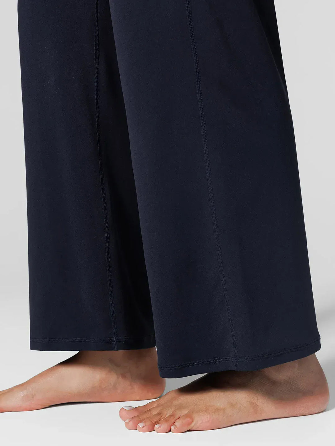 A model wearing a BRXL® Tummy Control Wide Leg Activewear Leggings in