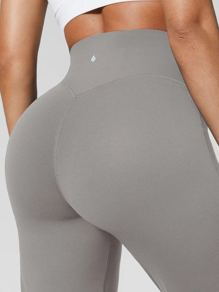 A model wearing a BRXL® Tummy Control Wide Leg Activewear Leggings in