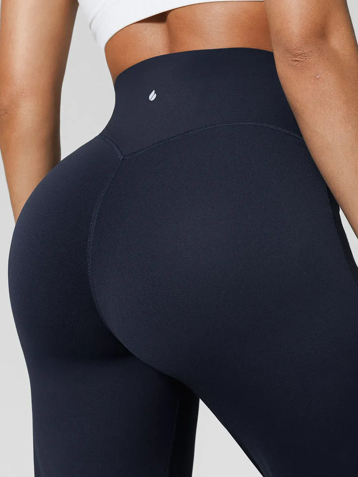 A model wearing a BRXL® Tummy Control Wide Leg Activewear Leggings in