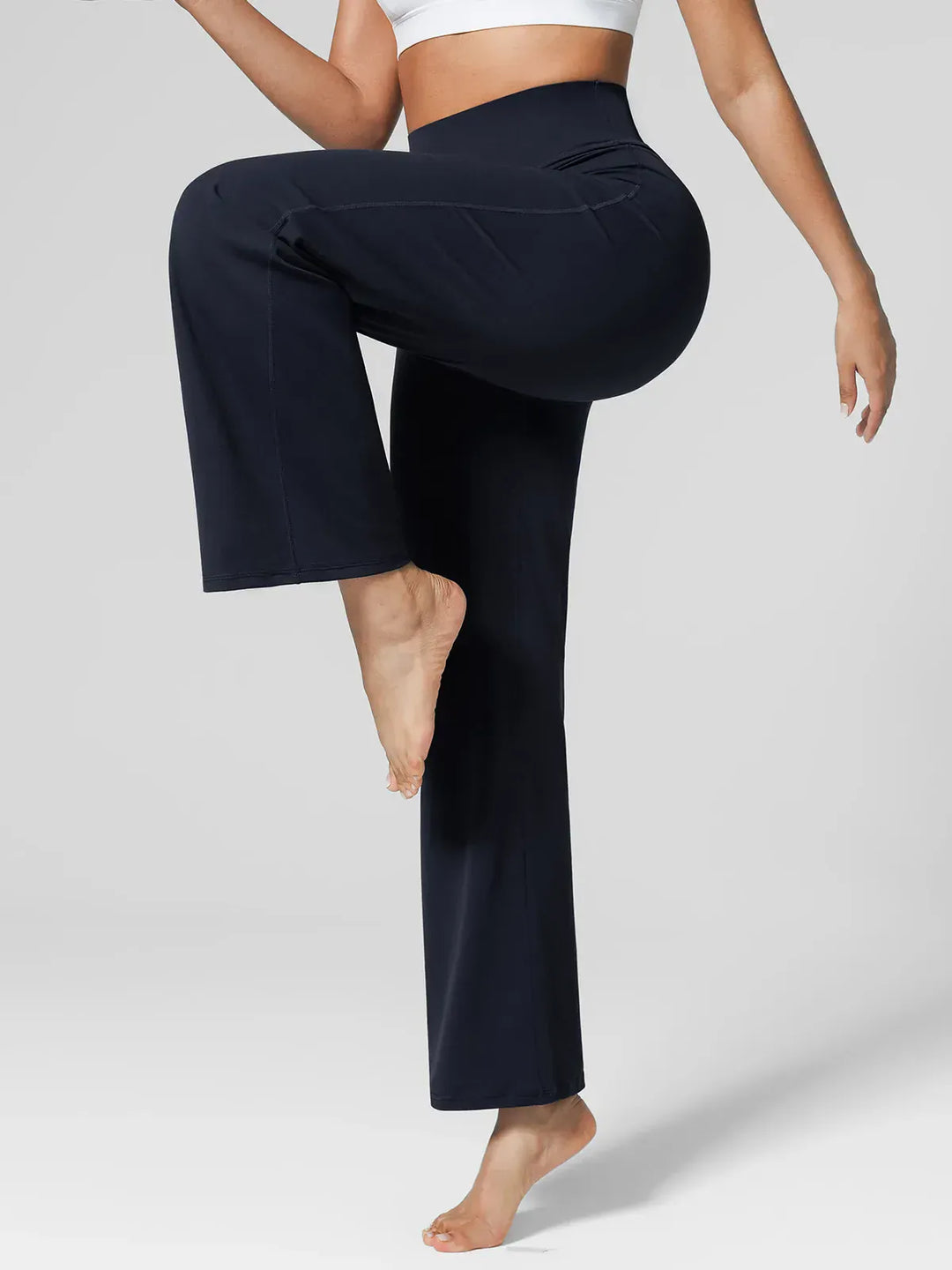 A model wearing a BRXL® Tummy Control Wide Leg Activewear Leggings in