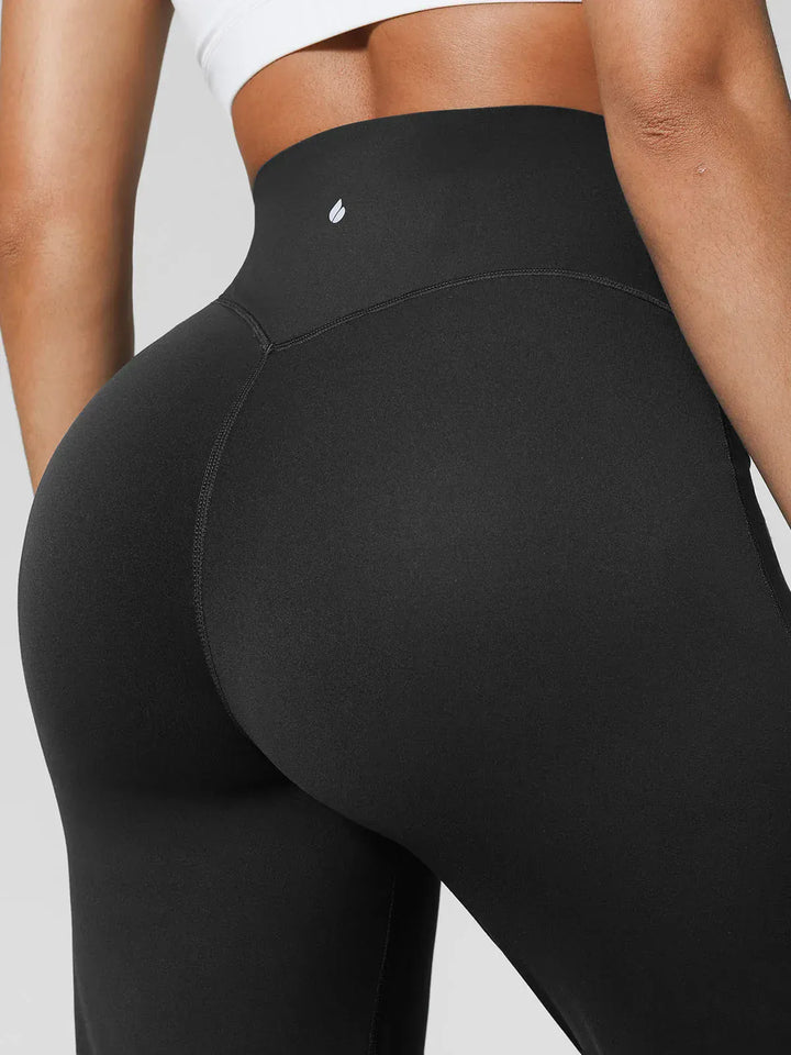 A model wearing a BRXL® Tummy Control Wide Leg Activewear Leggings in