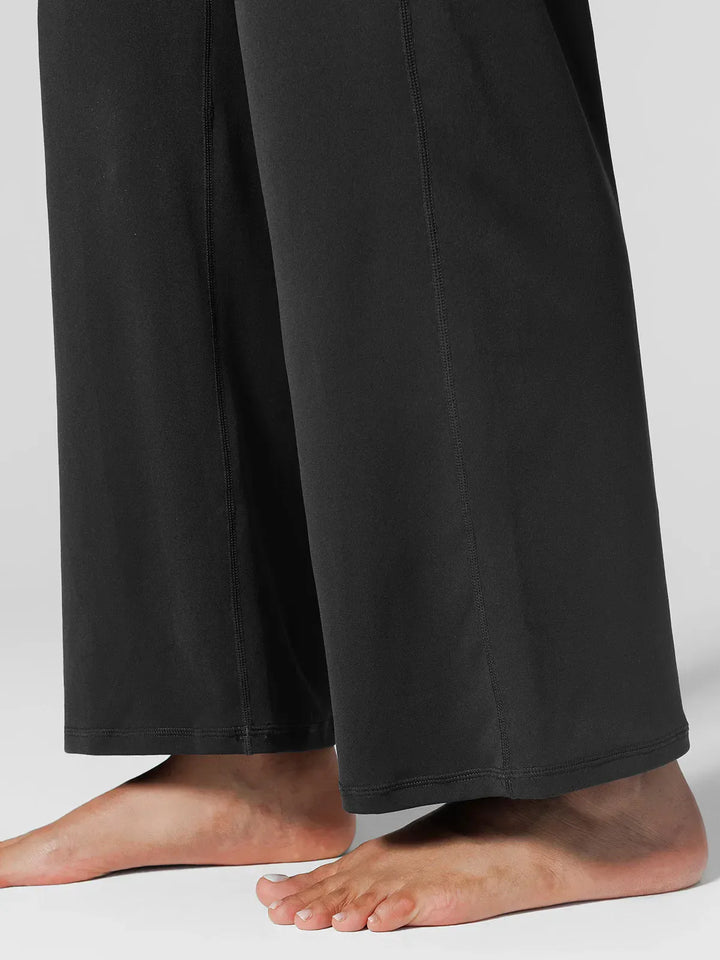 A model wearing a BRXL® Tummy Control Wide Leg Activewear Leggings in