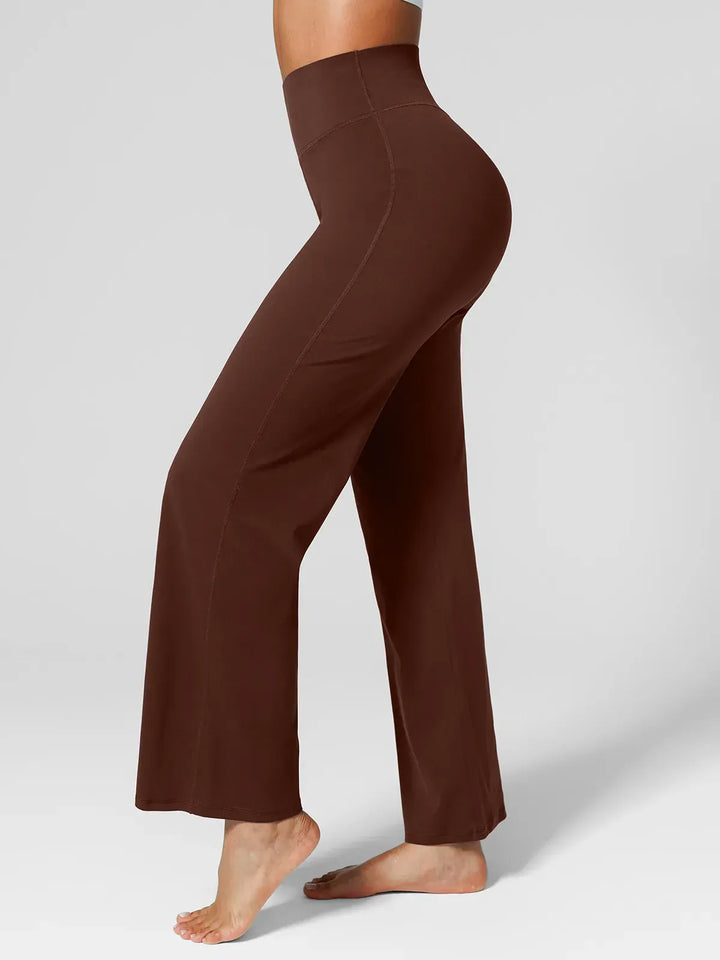 A model wearing a BRXL® Tummy Control Wide Leg Activewear Leggings in Brown / XS