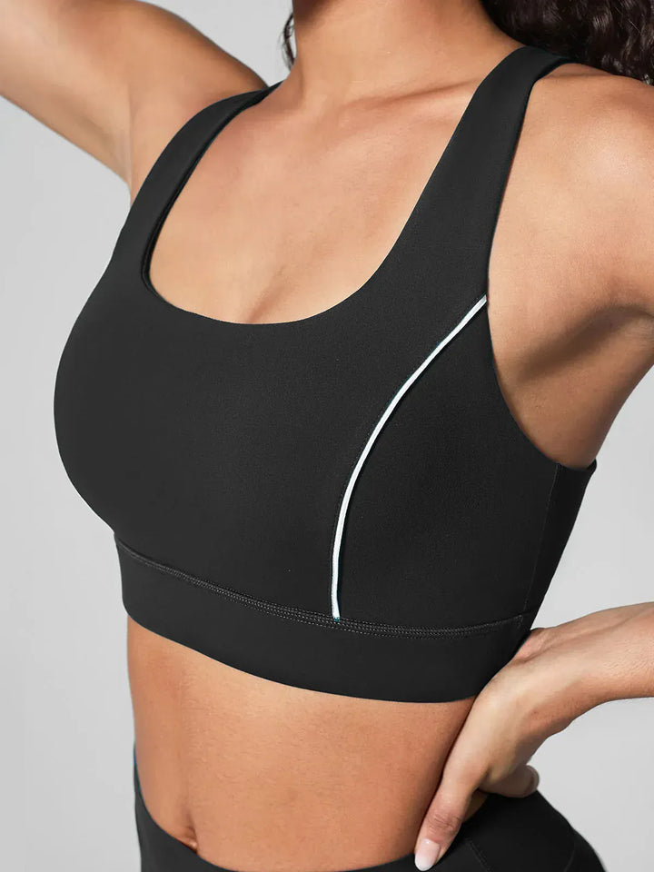 A model wearing a BRXL® Wide Strap Yoga-Friendly Sports Bra