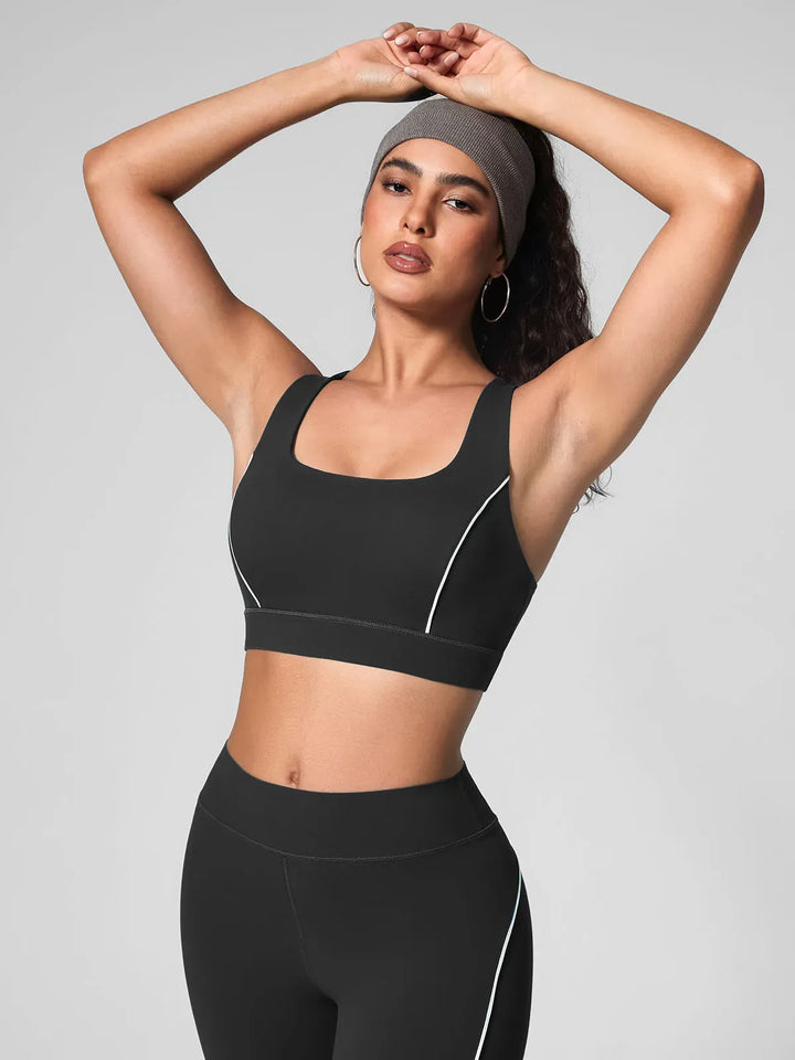 A model wearing a BRXL® Wide Strap Yoga-Friendly Sports Bra