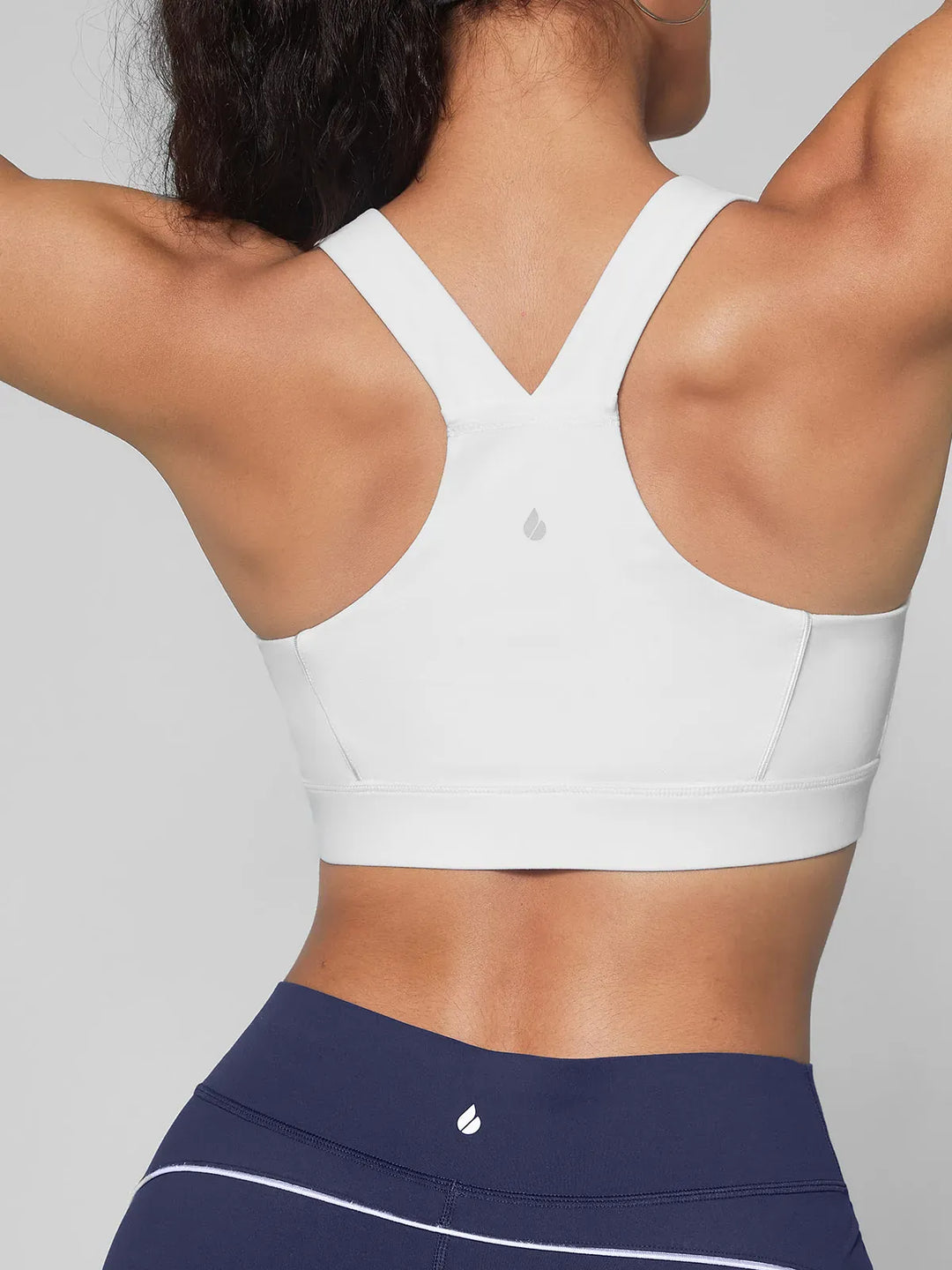 A model wearing a BRXL® Wide Strap Yoga-Friendly Sports Bra in