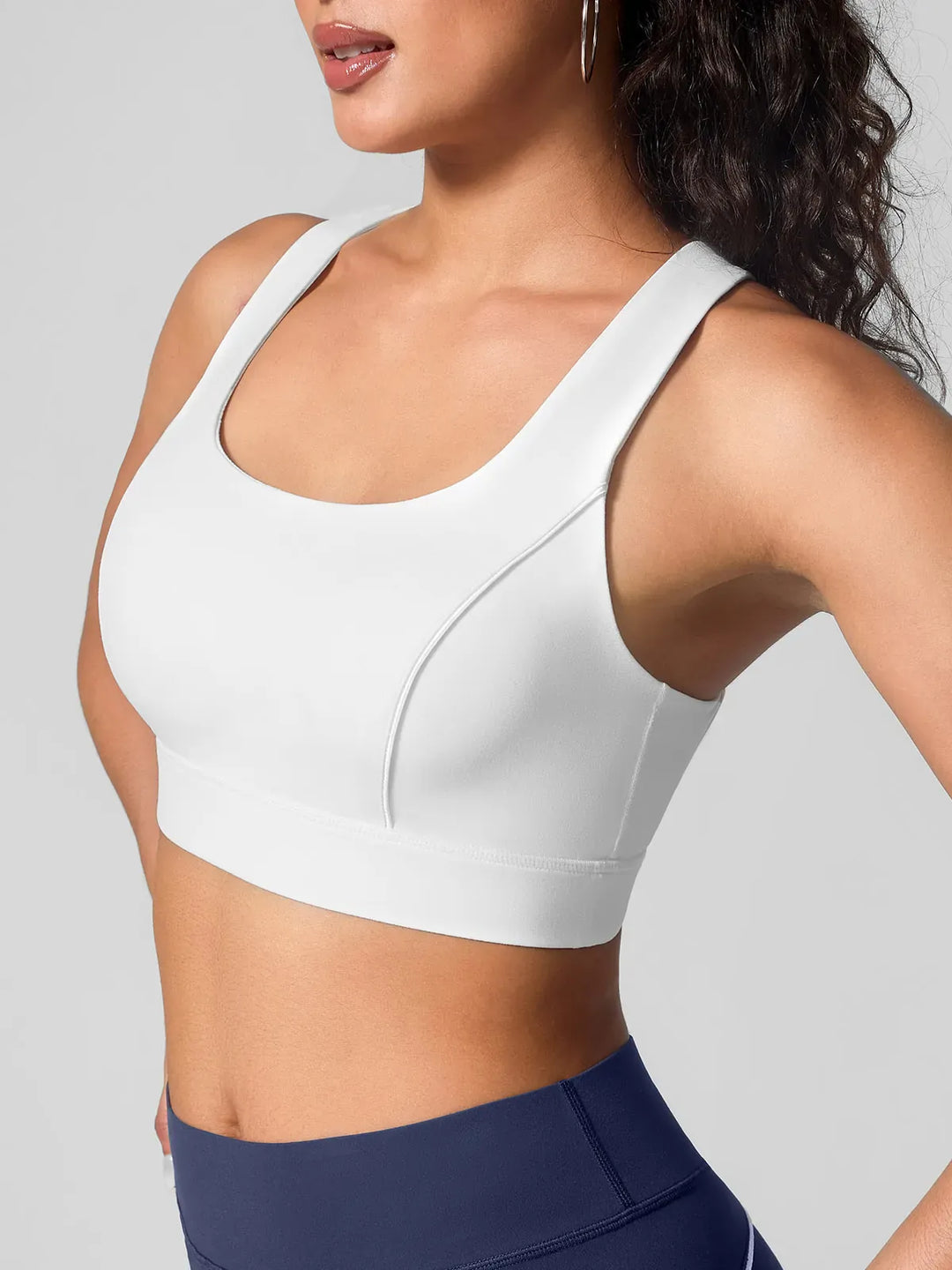 A model wearing a BRXL® Wide Strap Yoga-Friendly Sports Bra