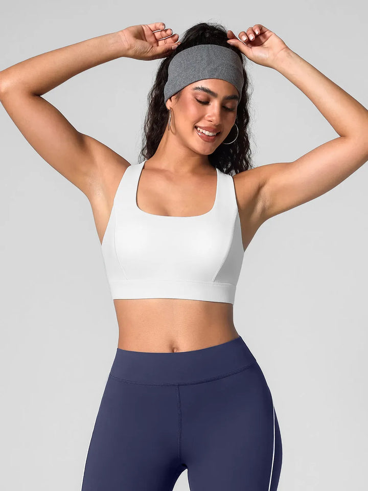 A model wearing a BRXL® Wide Strap Yoga-Friendly Sports Bra